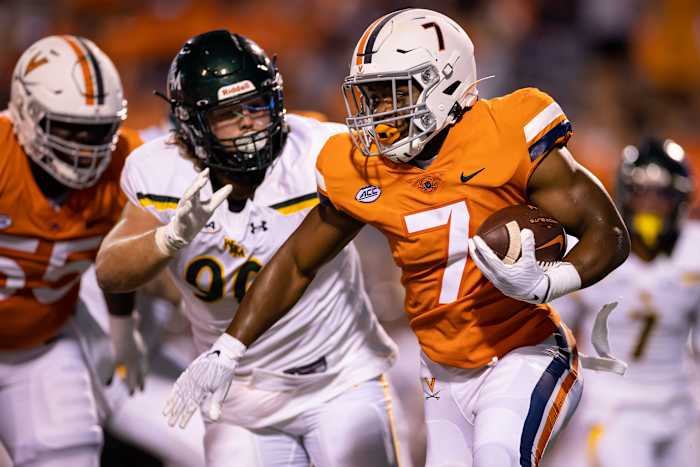 Virginia Cavaliers running back Mike Hollins (7) carries the ball against William & Mary Tribe defensive lineman Will Kiely (90) during the second half at Scott Stadium.